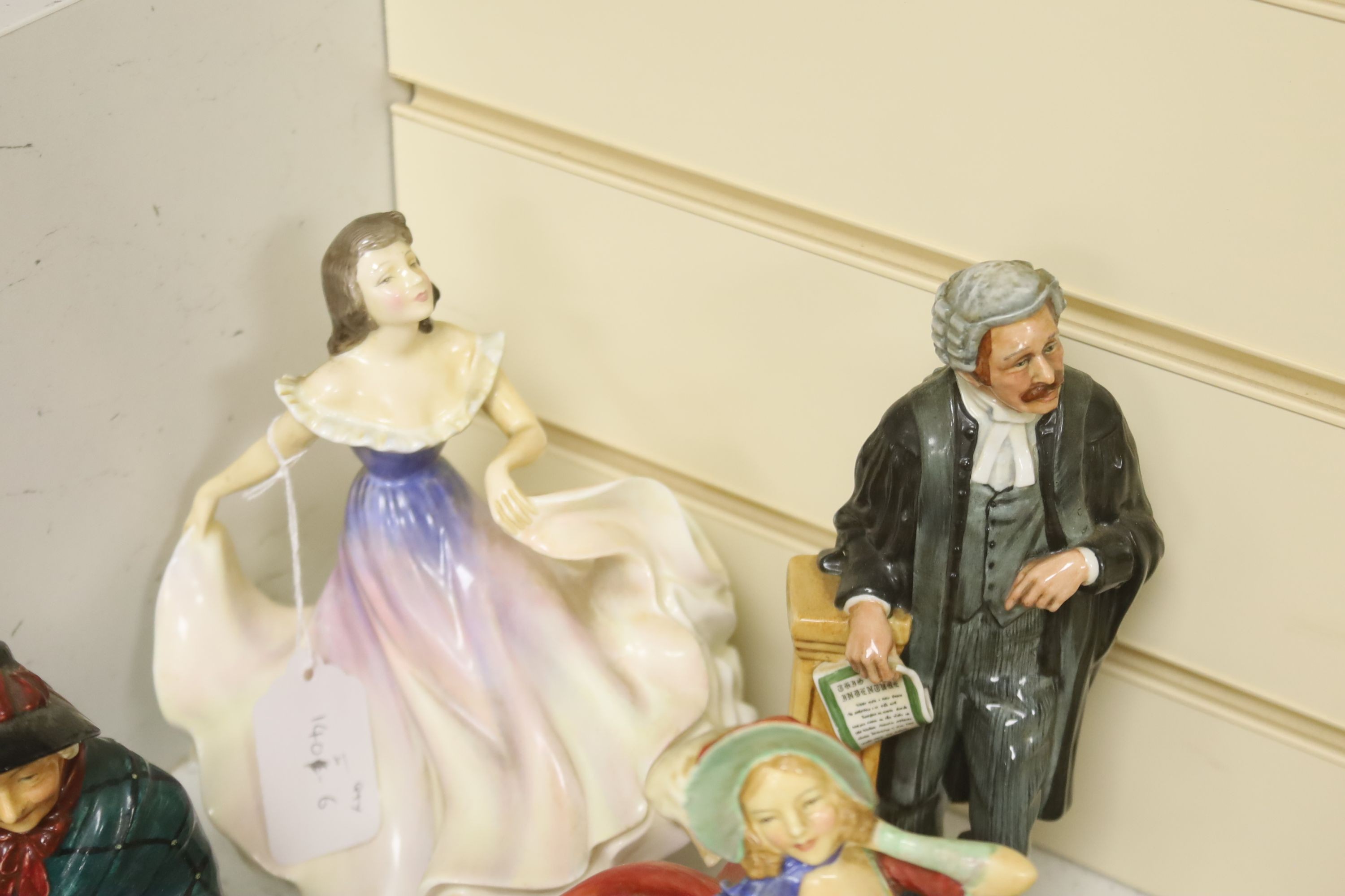 A group of 12 Royal Doulton figures and four plates